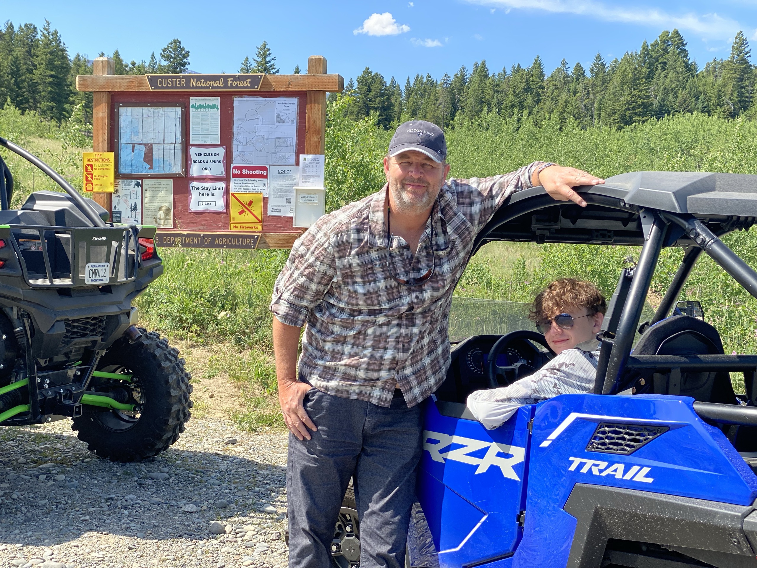 Father and son with RZR side-by-side in Custer National Forest
