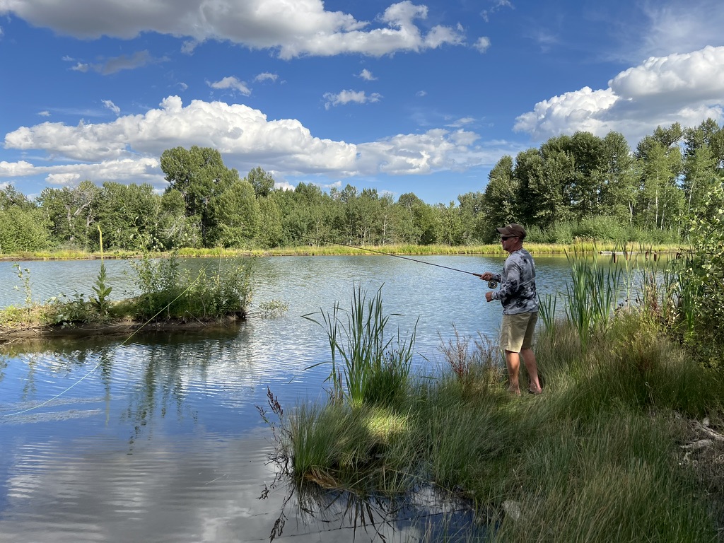 Angler casting on a private spring-fed pond