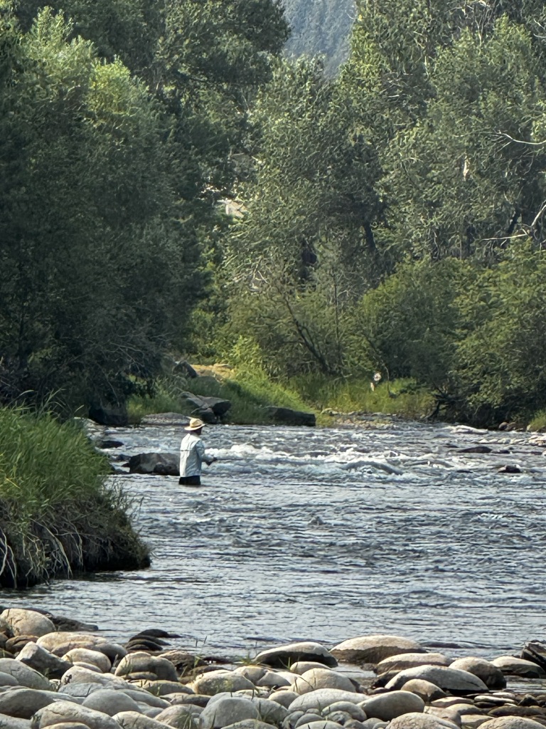Guide and angler reading a Montana river