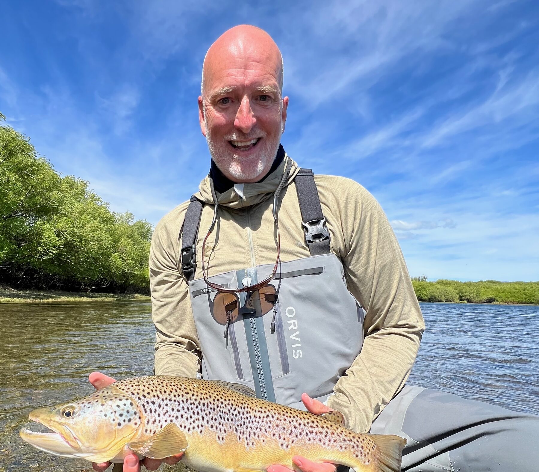 Lincoln Powers holding a wild brown trout on the river